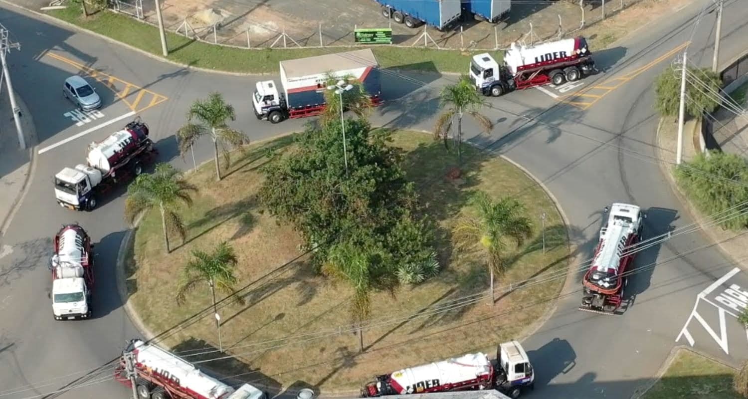 Caminhões-tanque da Líder Serviços contornando uma rotatória, vistos do alto
